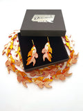 goldfish hoop earrings in a gift box surrounded by goldfish charms