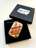 the sardine necklace can side up in its gift box