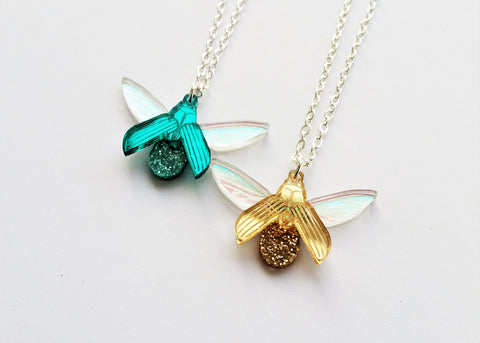 teal and gold glitterbug pendants 