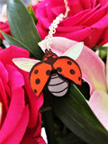 ladybird pendant on flowers