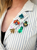 collection of bug brooches being worn.