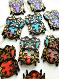 multiple jumping spider pendants showing the iridescent colour changes 
