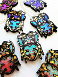 multiple jumping spider pendants showing the iridescent colour changes