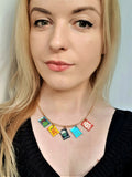 woman wearing the snack charm necklace, crisp necklace