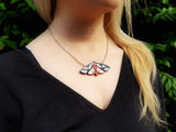 woman wearing the tiger moth necklace